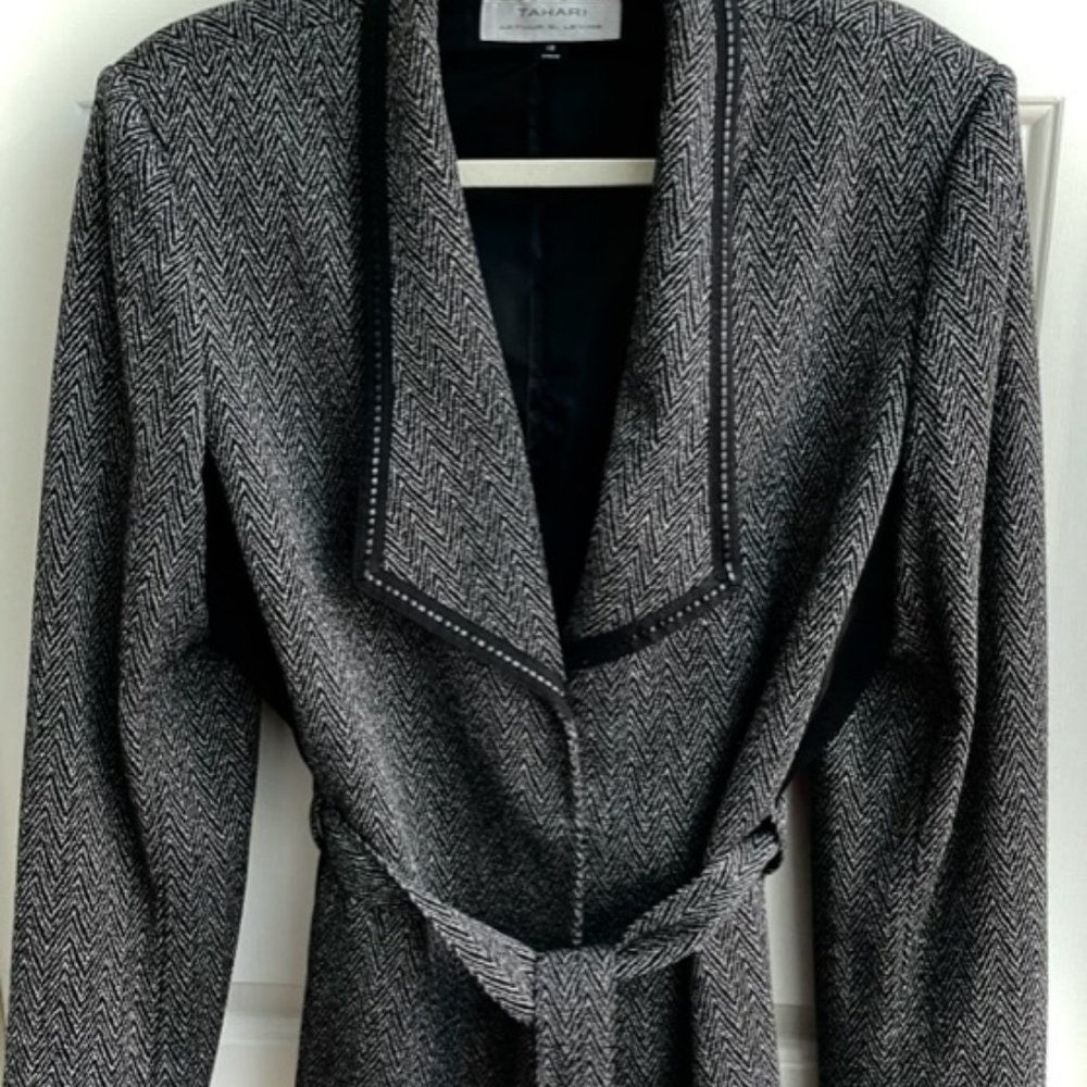 This is a Tahari jacket in a tweed fabric which is polyester and rayon.